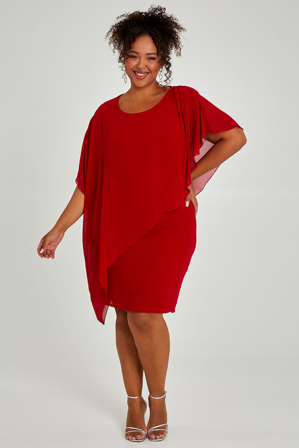 Model Alexis wearing size 16 of the Beatrice Dress in colour Red (Red), from the front, showing the whole outfit