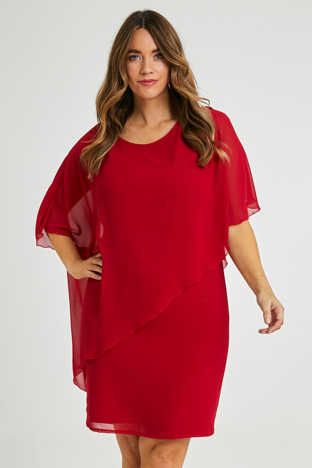 Model Laura wearing size 14 of the Beatrice Dress in colour Red (Red), from the front, cropped image