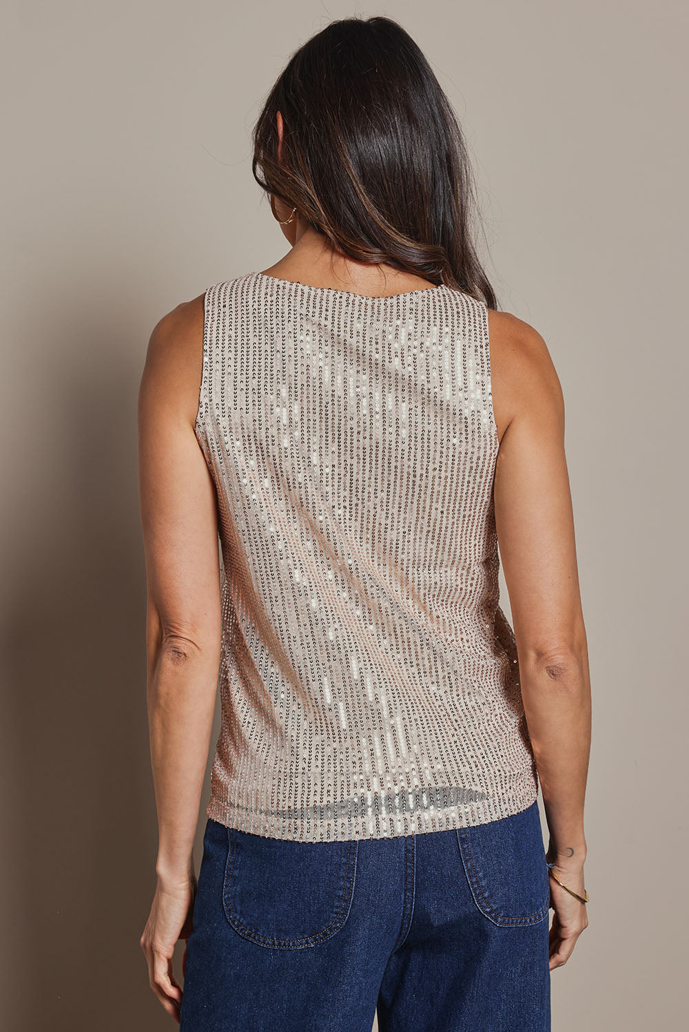 Model Amanda wearing size 10 of the Reece Top in colour Rosegold (Metallics), from the back