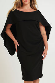 Model Chanel wearing size 16 of the Cora Dress in colour Black (Black), from the front, cropped image