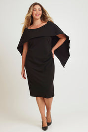Model Chanel wearing size 16 of the Cora Dress in colour Black (Black), from the front, showing the whole outfit