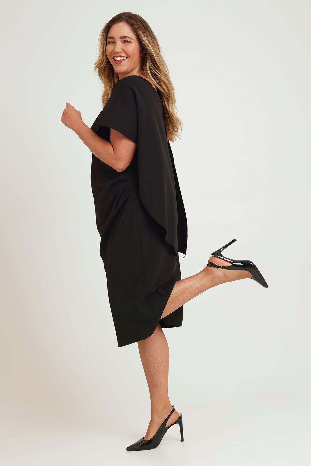 Model Chanel wearing size 16 of the Cora Dress in colour Black (Black), from the front, showing the whole outfit