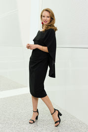 Model Katie wearing size 10 of the Cora Dress in colour Black (Black), from the front, showing the whole outfit