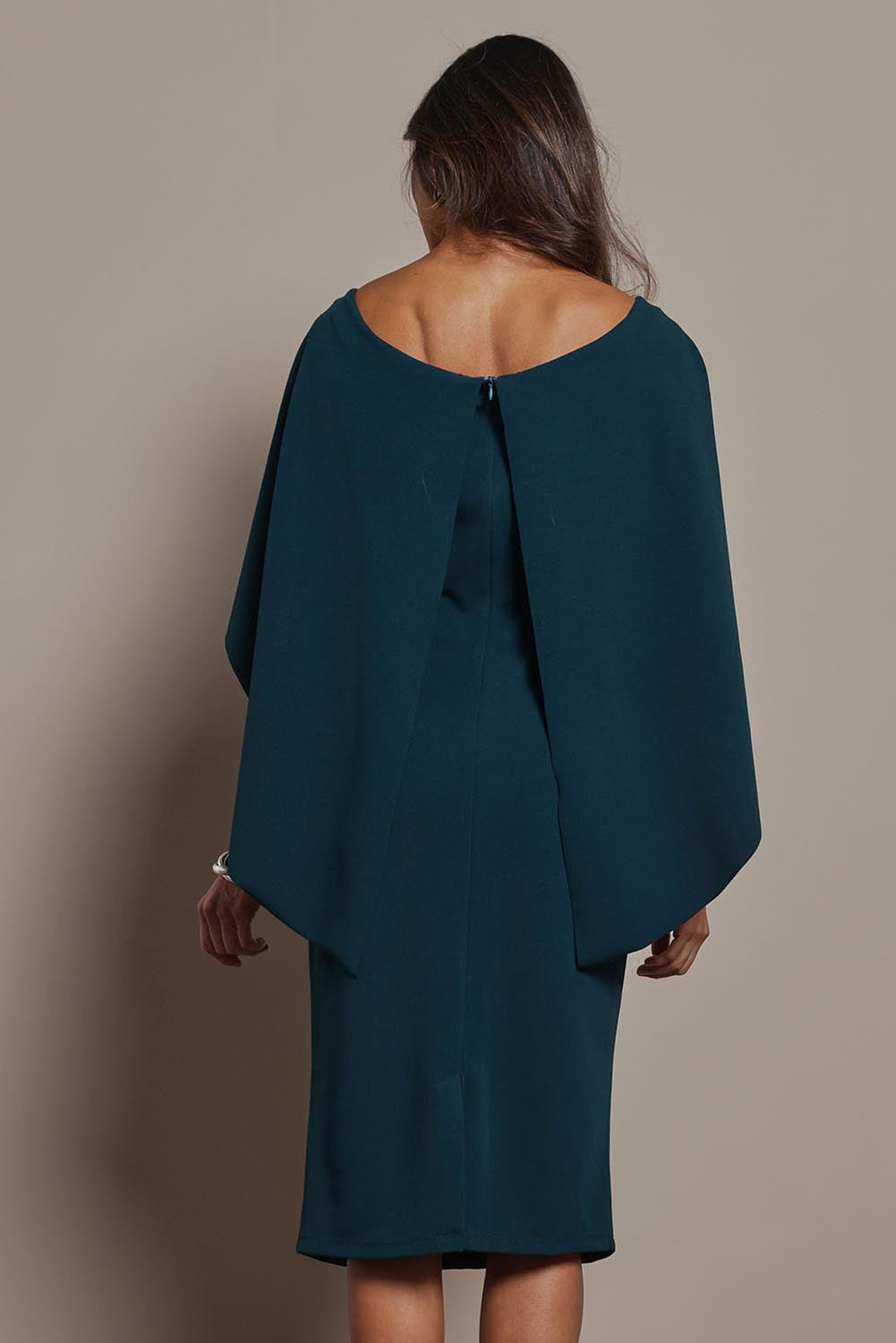 Model Amanda wearing size 10 of the Cora Dress in colour Darkteal (Green), from the back