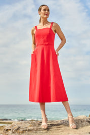 Model Clementine wearing size 10 of the Carmen Dress in colour Flame (Red), from the front, showing the whole outfit