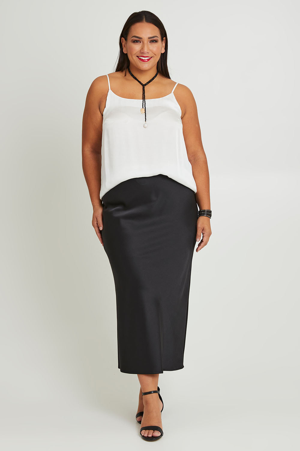 Model Ashleigh wearing size 16 of the Sienna Skirt in colour Black (Black), from the front, showing the whole outfit