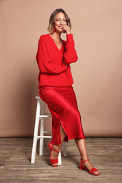 Model Riina wearing size 10 of the Loulou Satin Skirt in colour Red (Red), from the front, showing the whole outfit
