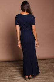 Model Amanda wearing size S of the Ellen Knit Dress in colour Midnight (Blue), from the back