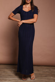 Model Amanda wearing size S of the Ellen Knit Dress in colour Midnight (Blue), from the front, cropped image