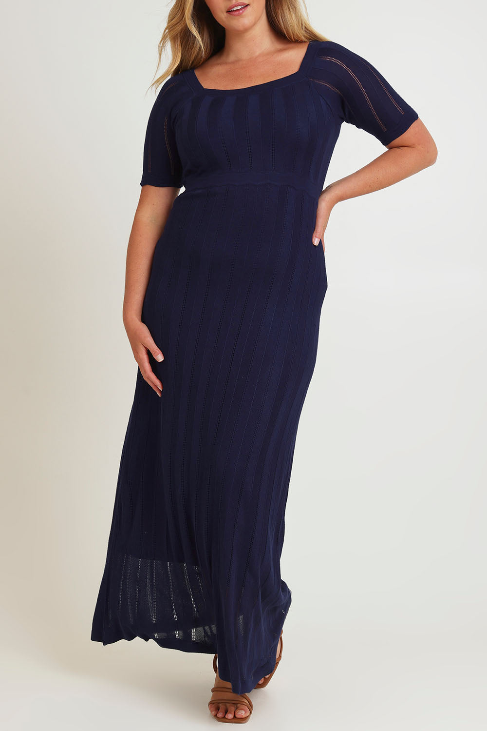 Model Chanel wearing size XL of the Ellen Knit Dress in colour Midnight (Blue), from the front, cropped image