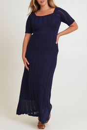Model Chanel wearing size XL of the Ellen Knit Dress in colour Midnight (Blue), from the front, cropped image