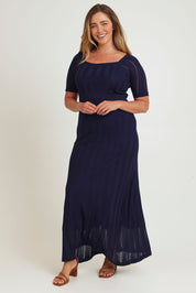 Model Chanel wearing size XL of the Ellen Knit Dress in colour Midnight (Blue), from the front, showing the whole outfit