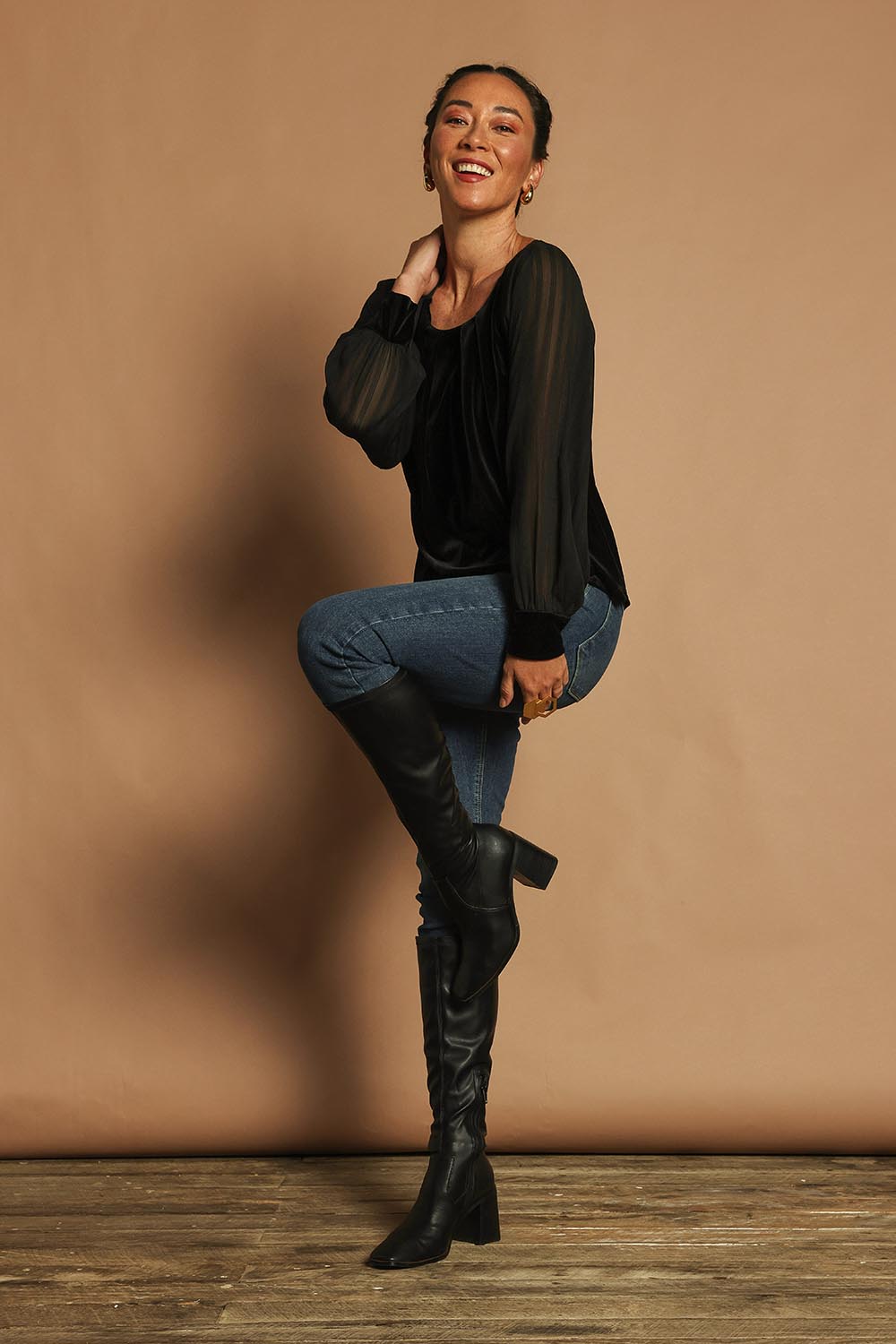Model Katie wearing size 10 of the Leyla Velvet Blouse in colour Black (Black), from the front, showing the whole outfit