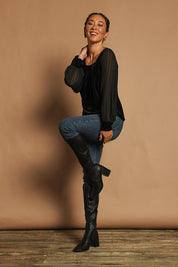 Model Katie wearing size 10 of the Leyla Velvet Blouse in colour Black (Black), from the front, showing the whole outfit
