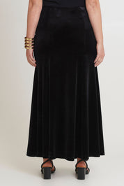 Model Chanel wearing size 16 of the Marlene Velvet Skirt in colour Black (Black), from the back