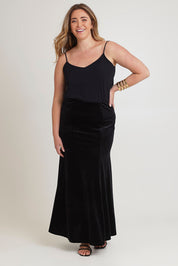 Model Chanel wearing size 16 of the Marlene Velvet Skirt in colour Black (Black), from the front, showing the whole outfit