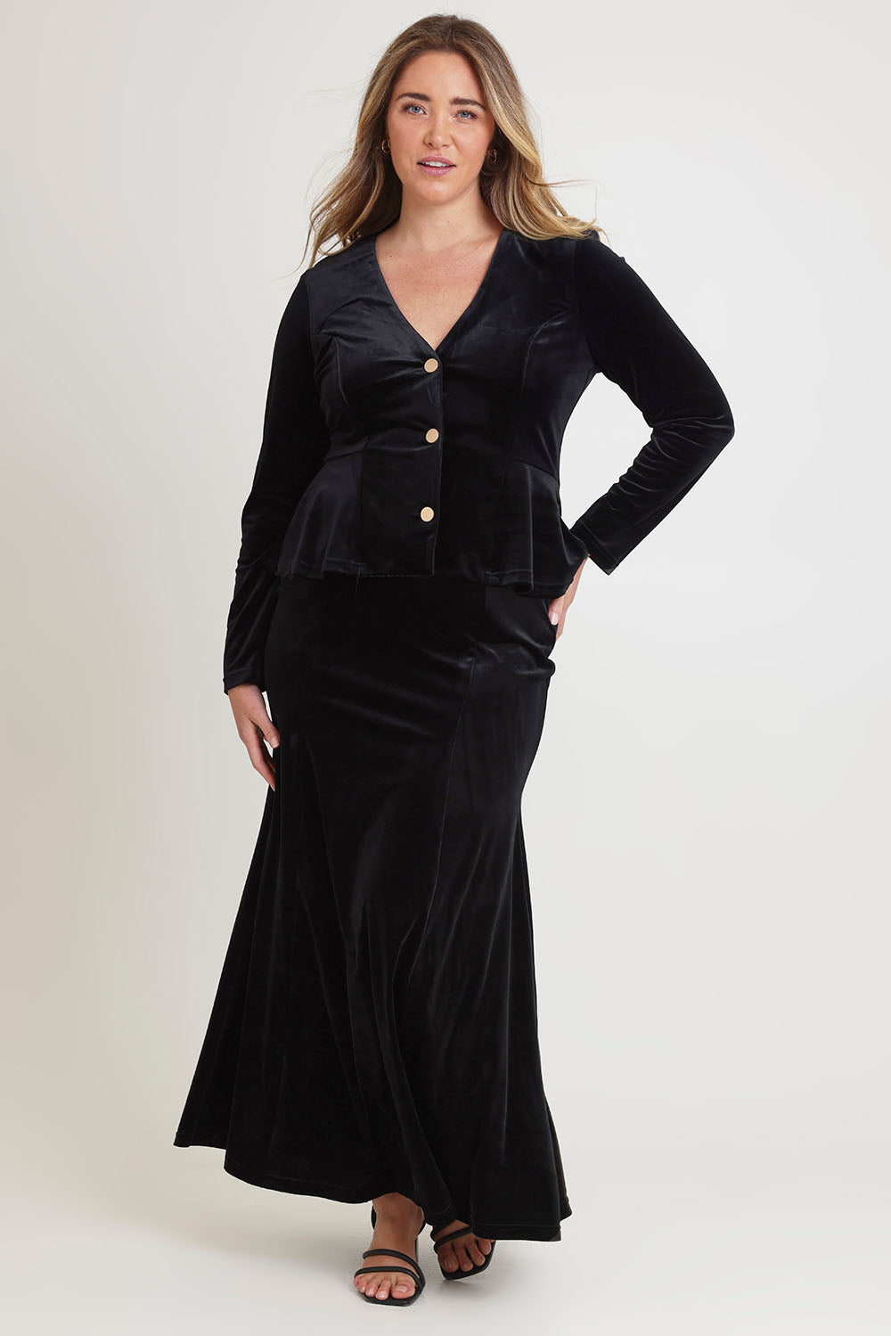 Model Chanel wearing size 16 of the Marlene Velvet Skirt in colour Black (Black), from the front, showing the whole outfit