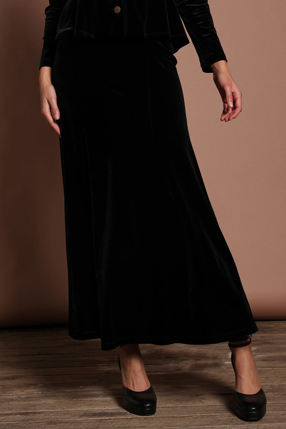 Model Madeline wearing size 10 of the Marlene Velvet Skirt in colour Black (Black), from the front, cropped image