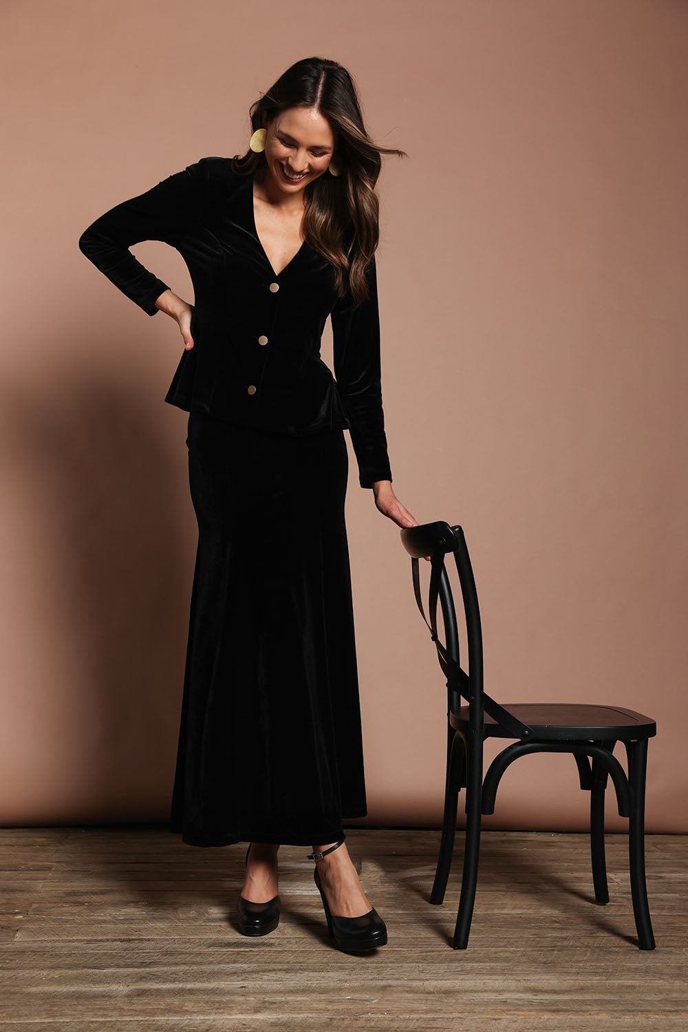 Model Madeline wearing size 10 of the Marlene Velvet Skirt in colour Black (Black), from the front, showing the whole outfit