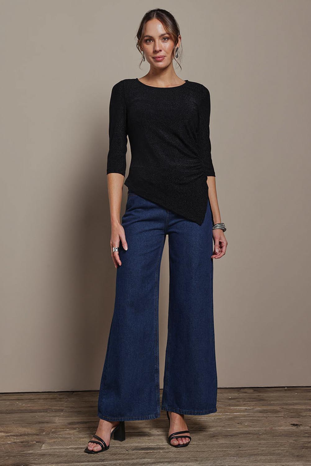 Model Madeline wearing size 10 of the Aisling Top in colour Black (Black), from the front, showing the whole outfit