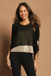 Model Madeline wearing size 10 of the Ria Top in colour Blackgold (Black), from the front, cropped image
