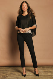 Model Madeline wearing size 10 of the Ria Top in colour Blackgold (Black), from the front, showing the whole outfit