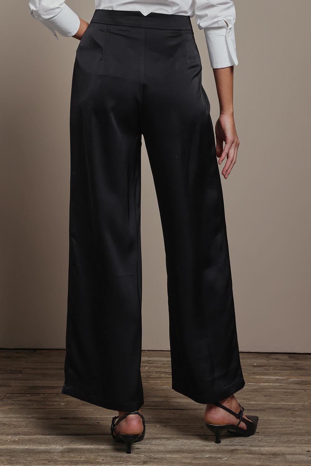 Model Madeline wearing size 10 of the Amelia Pants in colour Black (Black), from the back