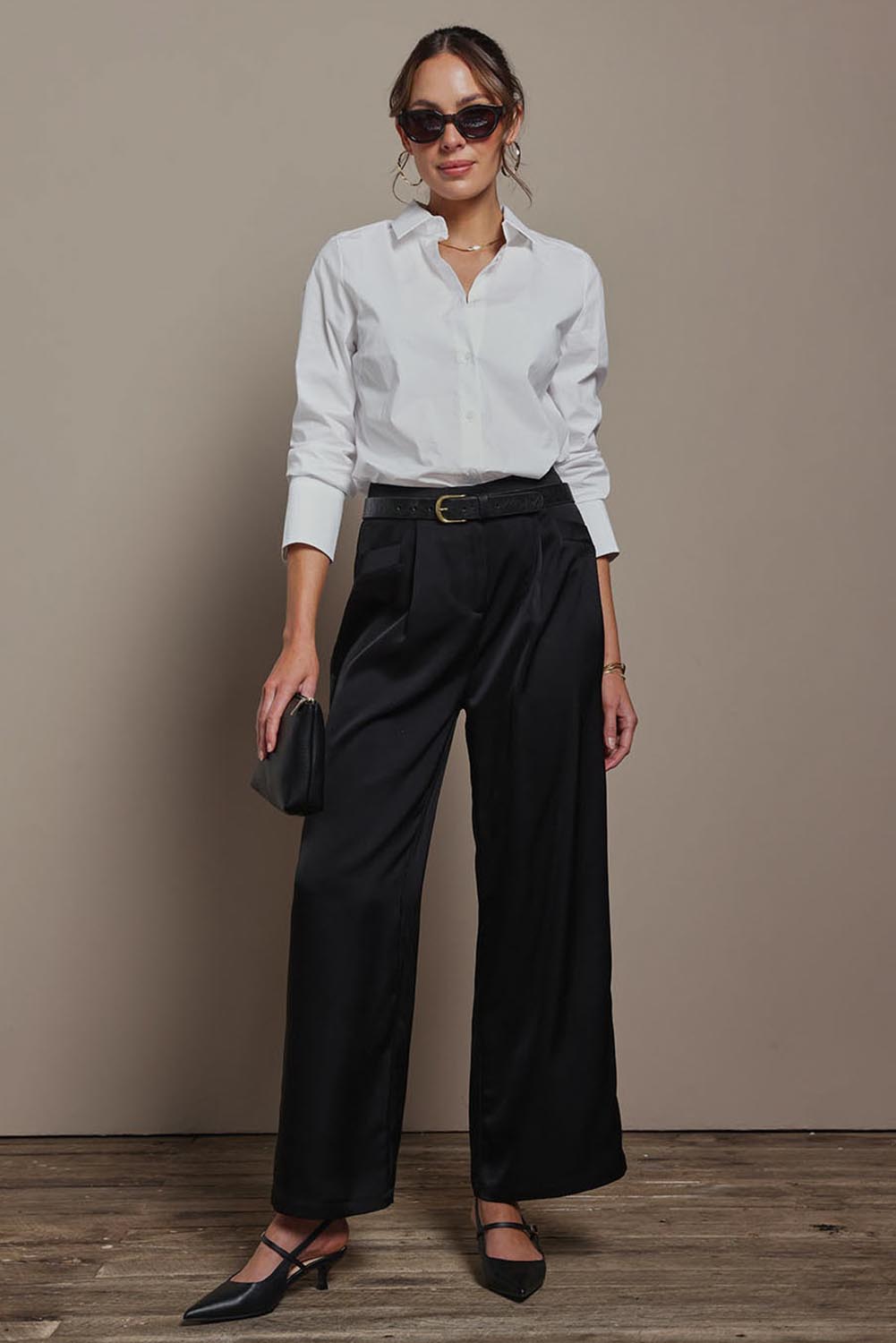 Model Madeline wearing size 10 of the Amelia Pants in colour Black (Black), from the front, showing the whole outfit