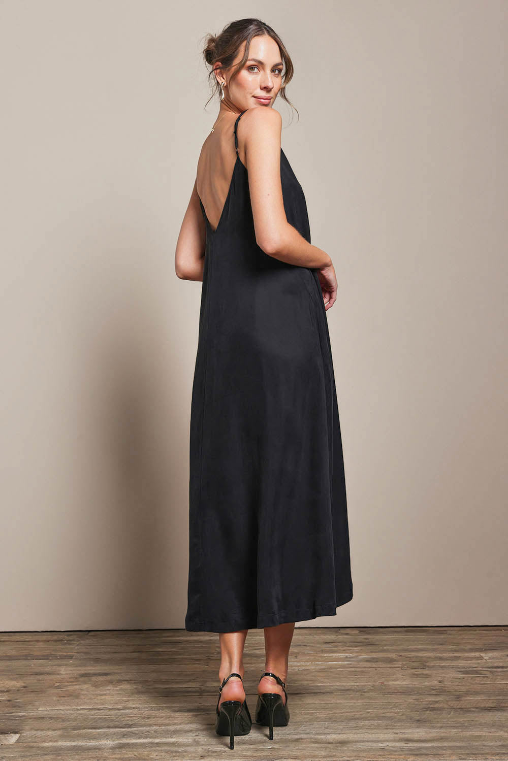 Model Madelinec wearing size 10 of the Edith Dress - Black in colour Black, from the front
