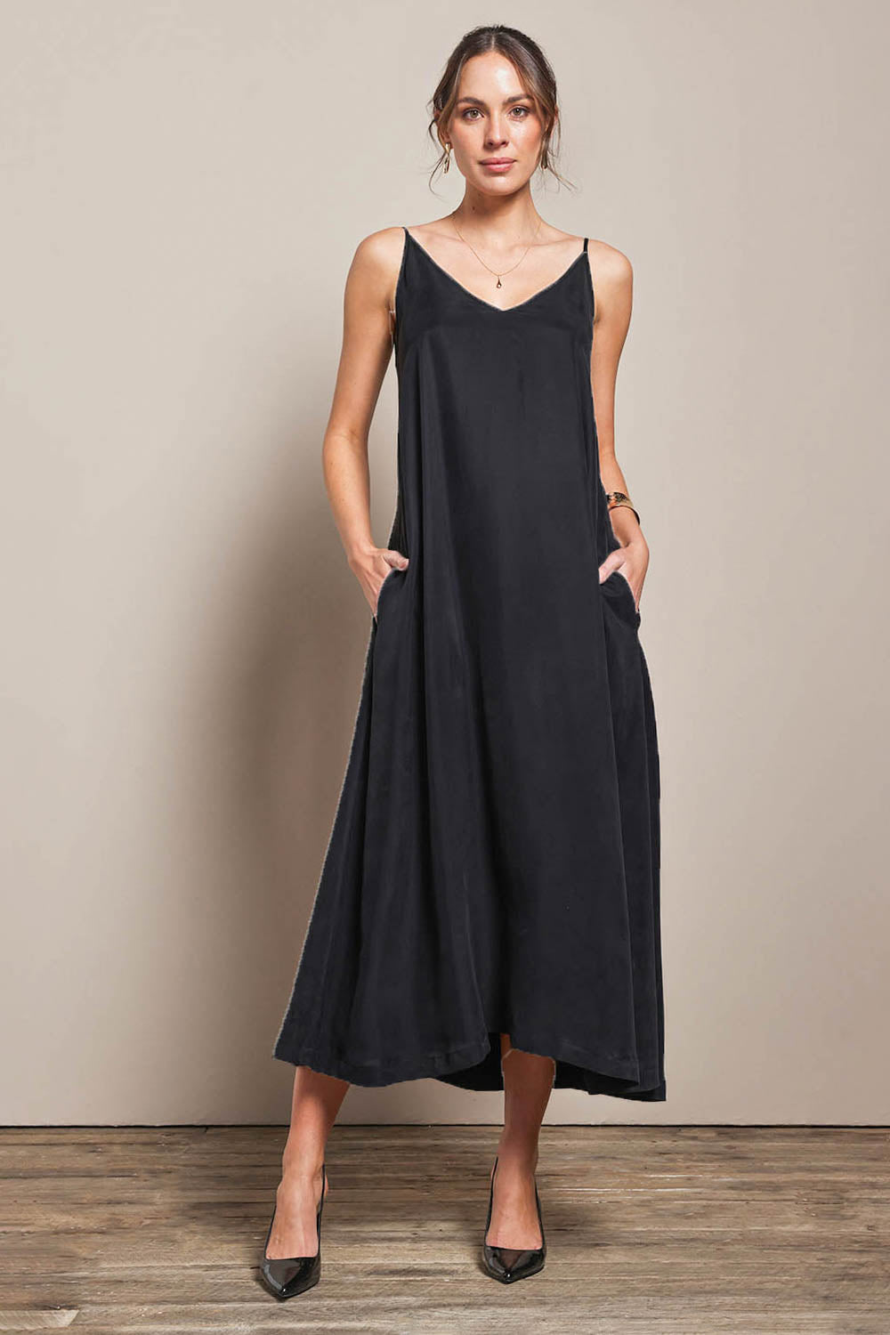 Model Madelinec wearing size 10 of the Edith Dress - Black in colour Black, from the front