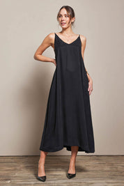 Model Madelinec wearing size 10 of the Edith Dress - Black in colour Black, from the front