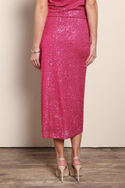 Model Maddiec wearing size 10 of the Reegan Sequin Skirt – Cerise in colour Cerise, from the back