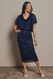 Model Amanda wearing size 10 of the Reegan Sequin Skirt in colour Navy (Metallics), from the front, showing the whole outfit