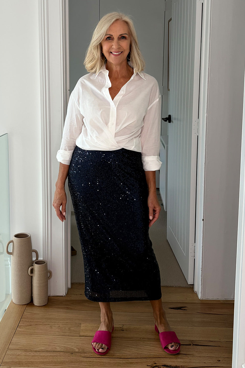 Model Sandy wearing size 10 of the Reegan Sequin Skirt in colour Navy (Metallics), from the front, showing the whole outfit
