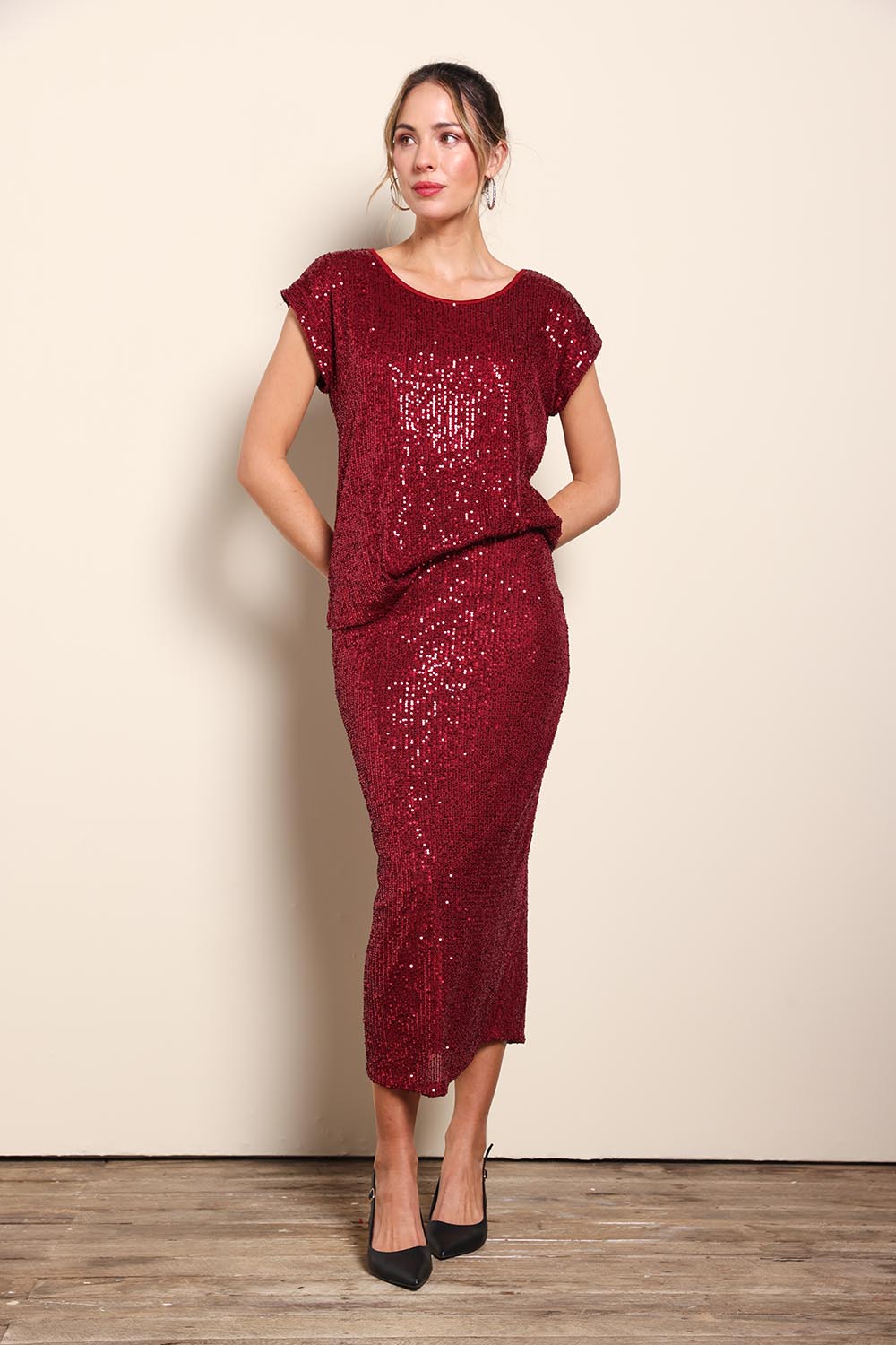 Model Maddiec wearing size 10 of the Reegan Sequin Skirt - Rouge in colour Rouge, from the front