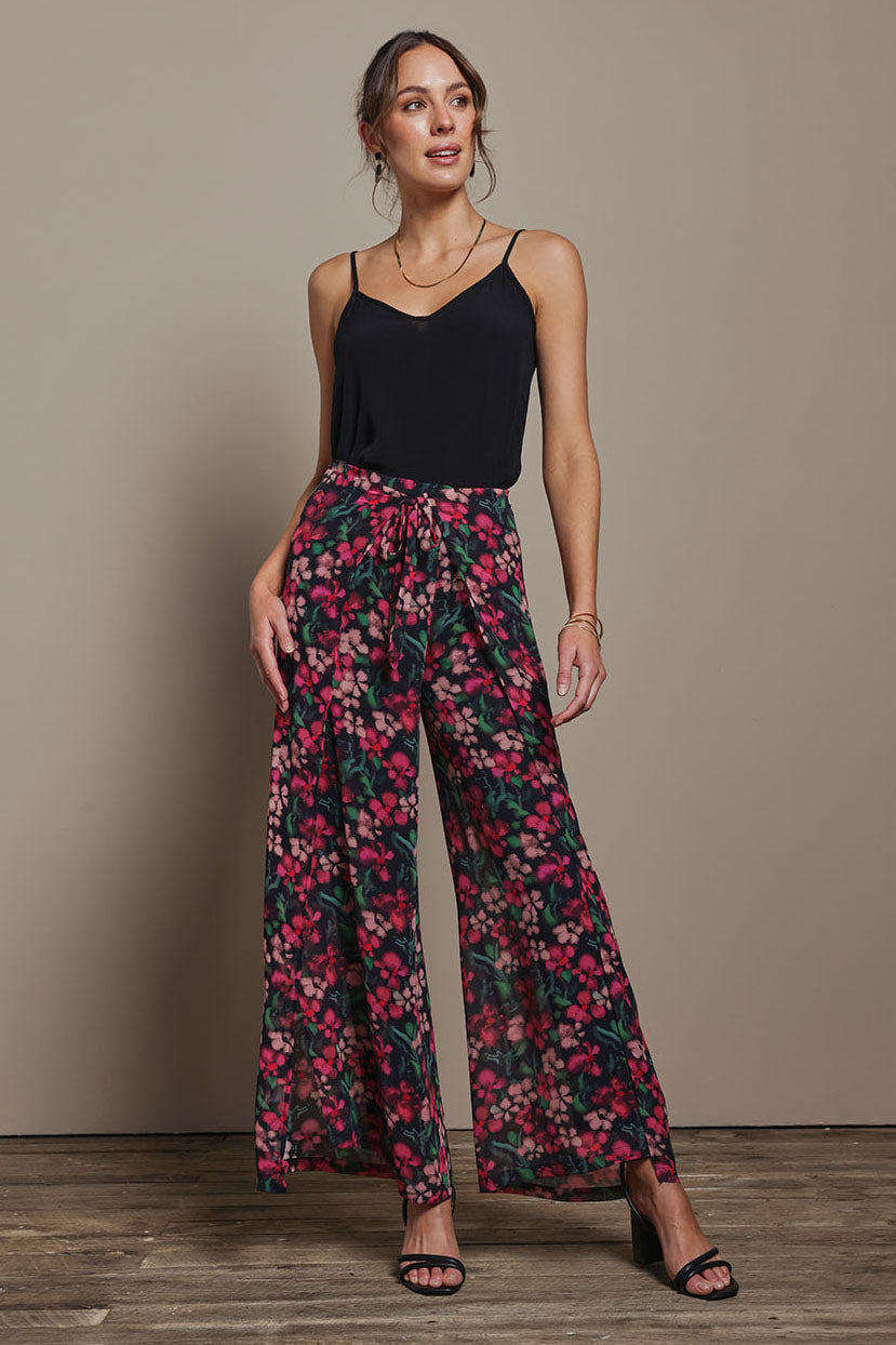 Model Madeline wearing size 10 of the Annette Pants in colour Blossom (Black), from the front, showing the whole outfit