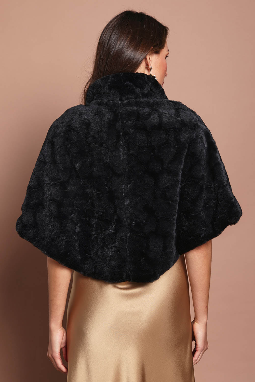 Model Madeline wearing size 10 of the Daphne Faux Fur Cape in colour Black (Black), from the back