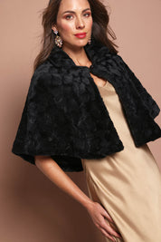 Model Madeline wearing size 10 of the Daphne Faux Fur Cape in colour Black (Black), from the front, cropped image