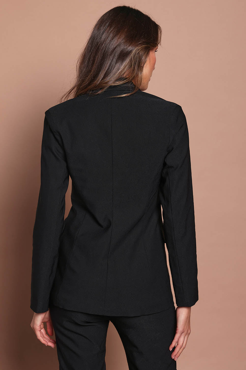Model Madeline wearing size 10 of the Holly Tuxedo Jacket in colour Black (Black), from the back