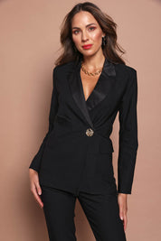 Model Madeline wearing size 10 of the Holly Tuxedo Jacket in colour Black (Black), from the front, cropped image