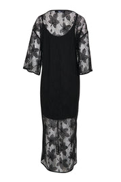 Product shot of the Nina Lace Dress - Black in colour Black, from the back