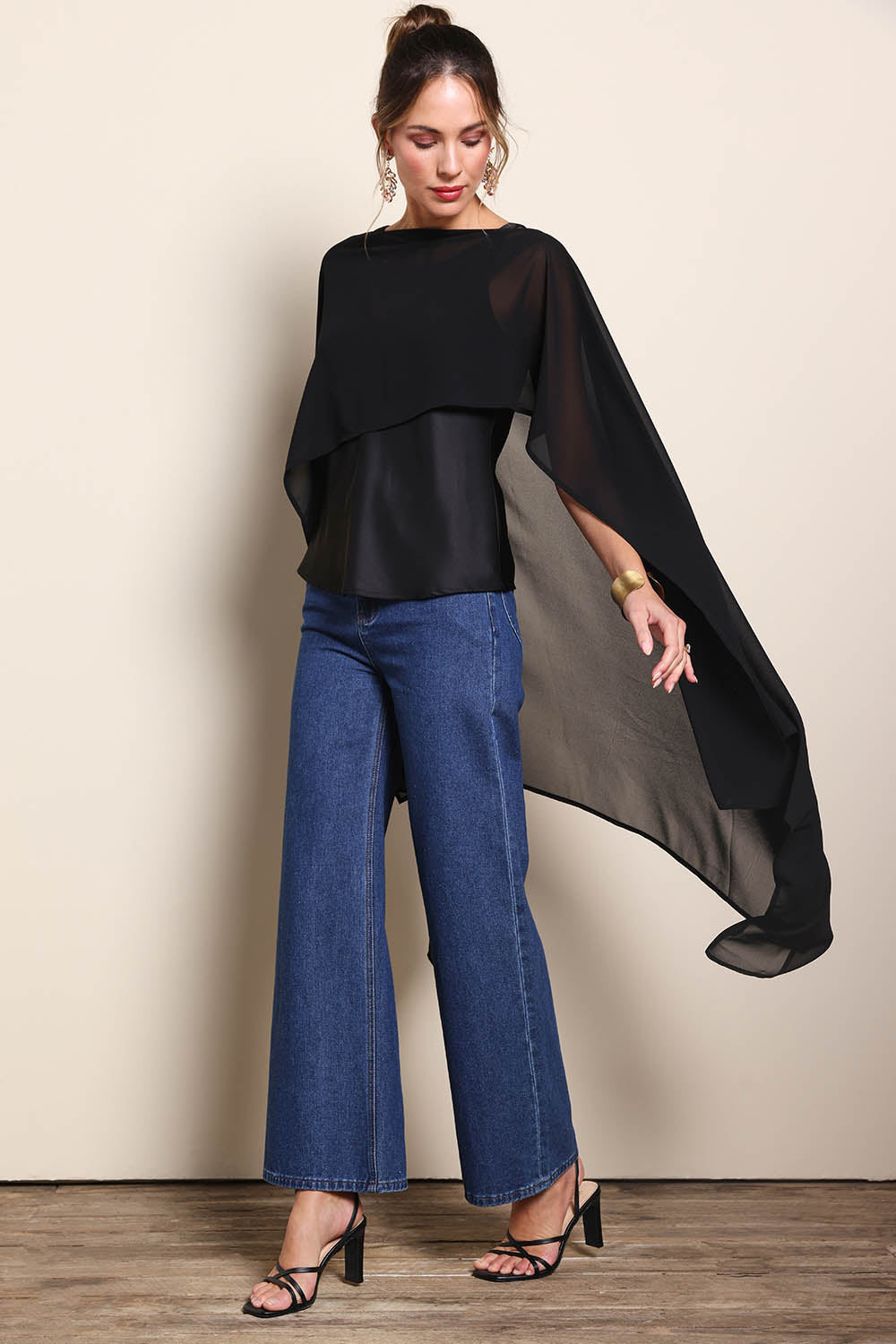 Model Maddiec wearing size 10 of the Freya Sheer Wrap – Black in colour Black, from the front
