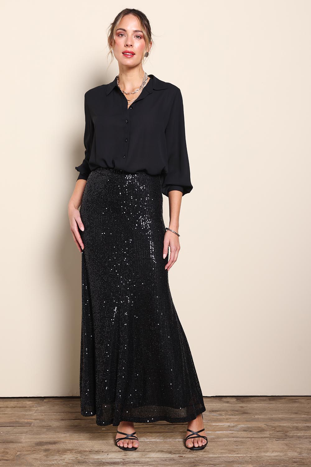 Model Maddiec wearing size 10 of the Remy Sequin Skirt – Black in colour Black, from the front