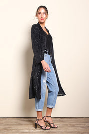 Model Maddiec wearing size 10 of the Reece Sequin Jacket – Black in colour Black, from the front