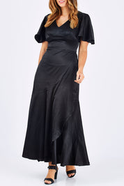 Model Laura wearing size 12 of the Fleur Dress in colour Black (Black), from the front, cropped image