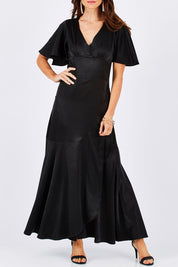 Model Monique wearing size 8 of the Fleur Dress in colour Black (Black), from the front, cropped image