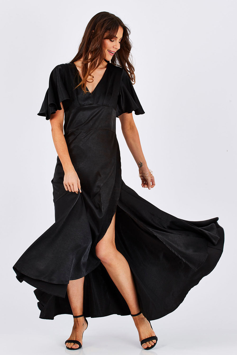 Model Monique wearing size 8 of the Fleur Dress in colour Black (Black), from the front, showing the whole outfit