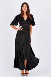 Model Monique wearing size 8 of the Fleur Dress in colour Black (Black), from the front, showing the whole outfit