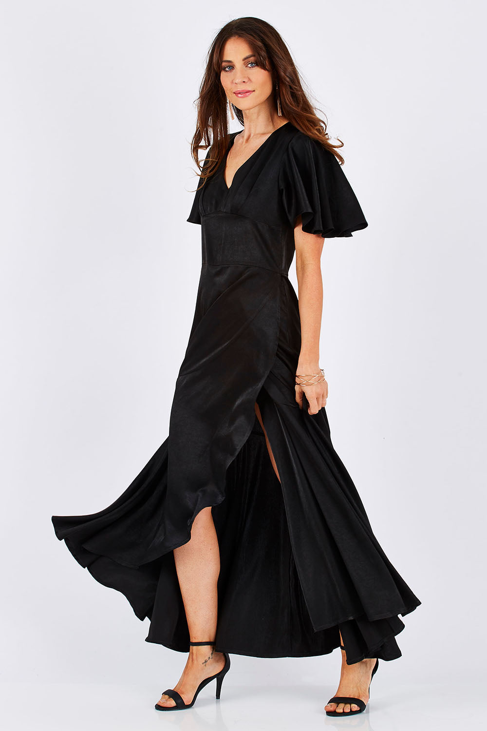 Model Monique wearing size 8 of the Fleur Dress in colour Black (Black), from the front, showing the whole outfit