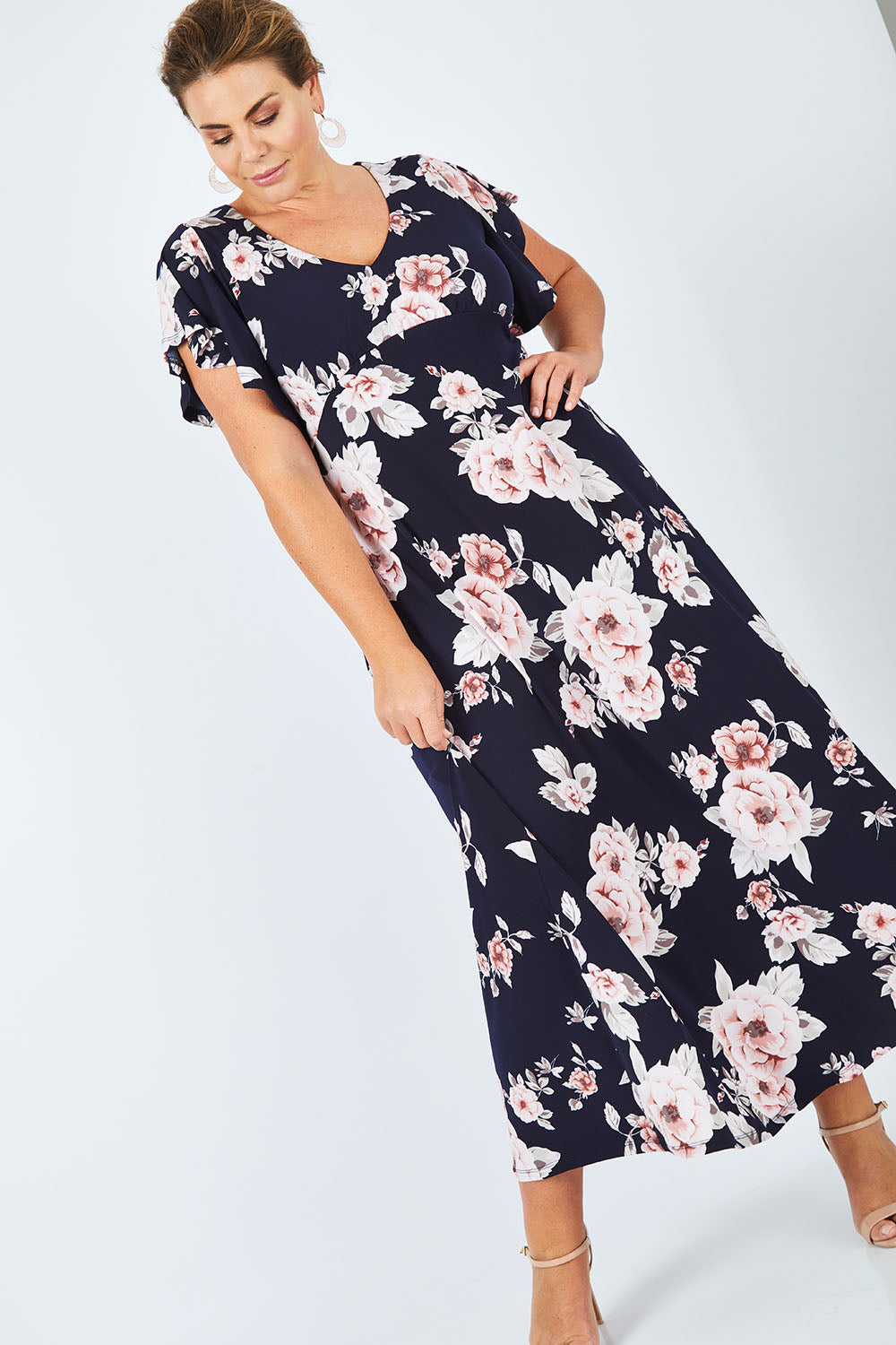 Model Fiona wearing size 16 of the Lucille Dress in colour NavyFloral (Blue), from the front, showing the whole outfit